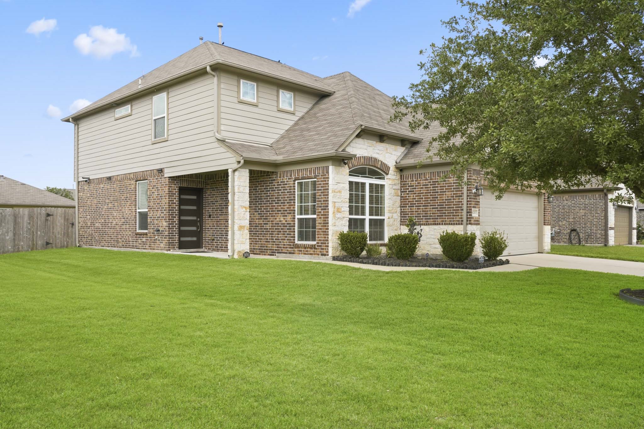 3010 Coachmaker Trail Rosenberg, TX 77471 - Photo 3 of 26 The home features a striking brick facade, a spacious two-story design, and a lush, well-maintained lawn that enhances its curb appeal.