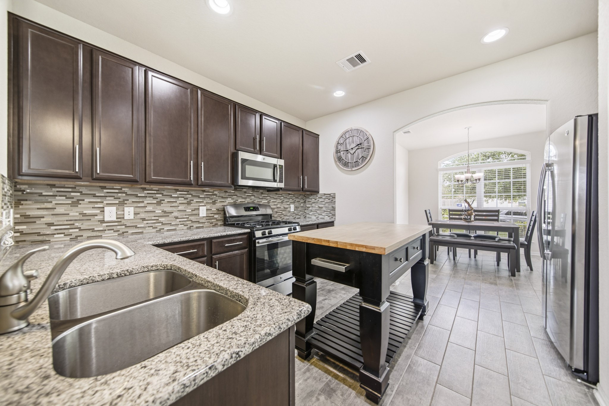 3010 Coachmaker Trail Rosenberg, TX 77471 - Photo 5 of 26 The kitchen features sleek stainless steel appliances paired with modern finishes, recessed and under cabinet, and access straight into your dining room.