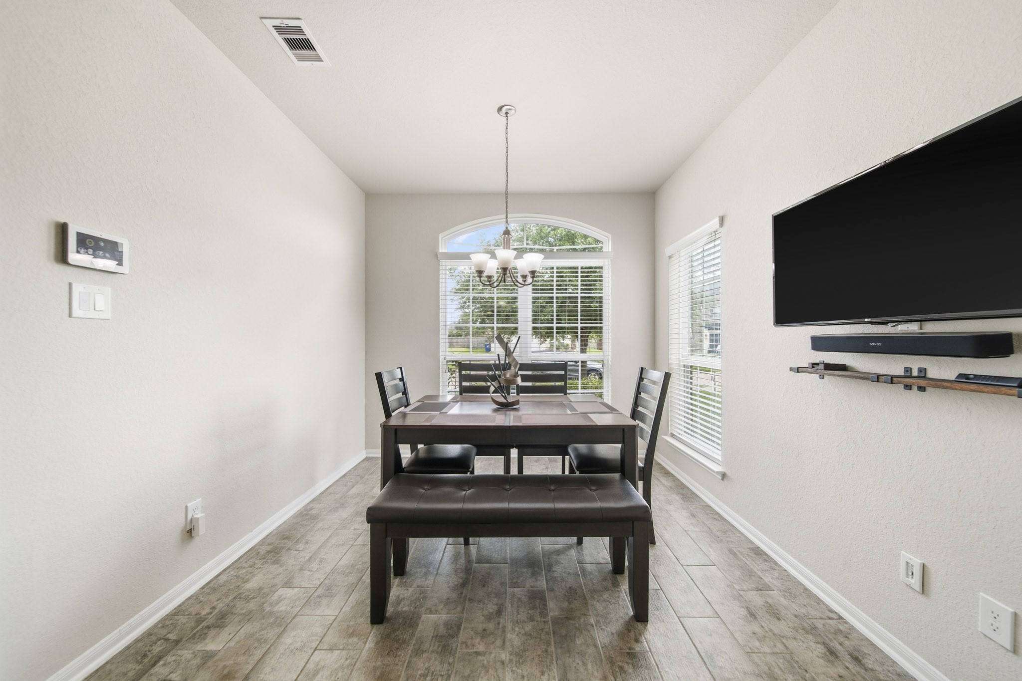 3010 Coachmaker Trail Rosenberg, TX 77471 - Photo 6 of 26 This dining area offers a well-proportioned space ideal for family gatherings. A stylish ceiling lamp provides warm, creating an inviting setting that’s both practical and comfortable for everyday dining and entertaining.