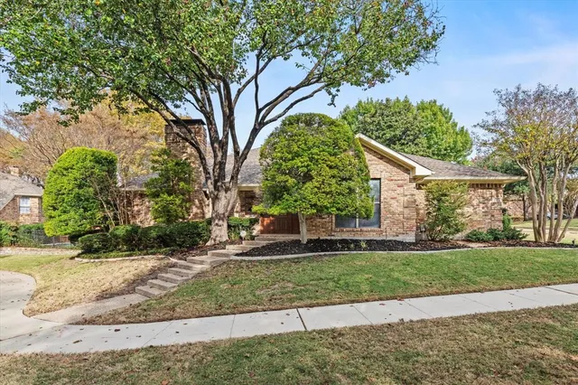 a front view of a house with a yard and a garage