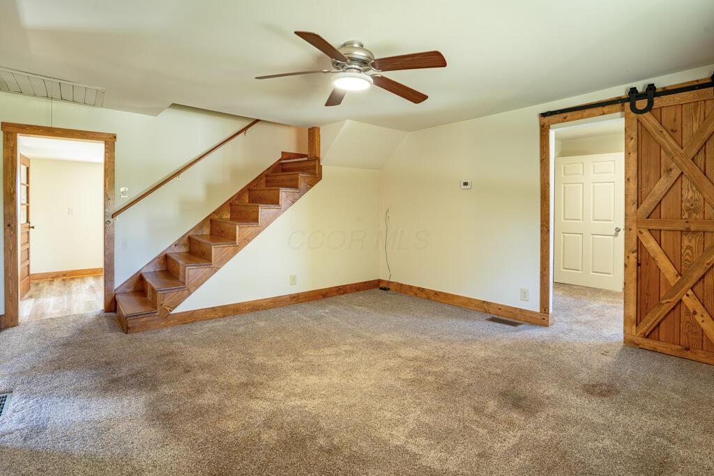 681 Downing Road Stockport, OH 43787 - Photo 5 of 36 Living Room Staircase and Barn Door