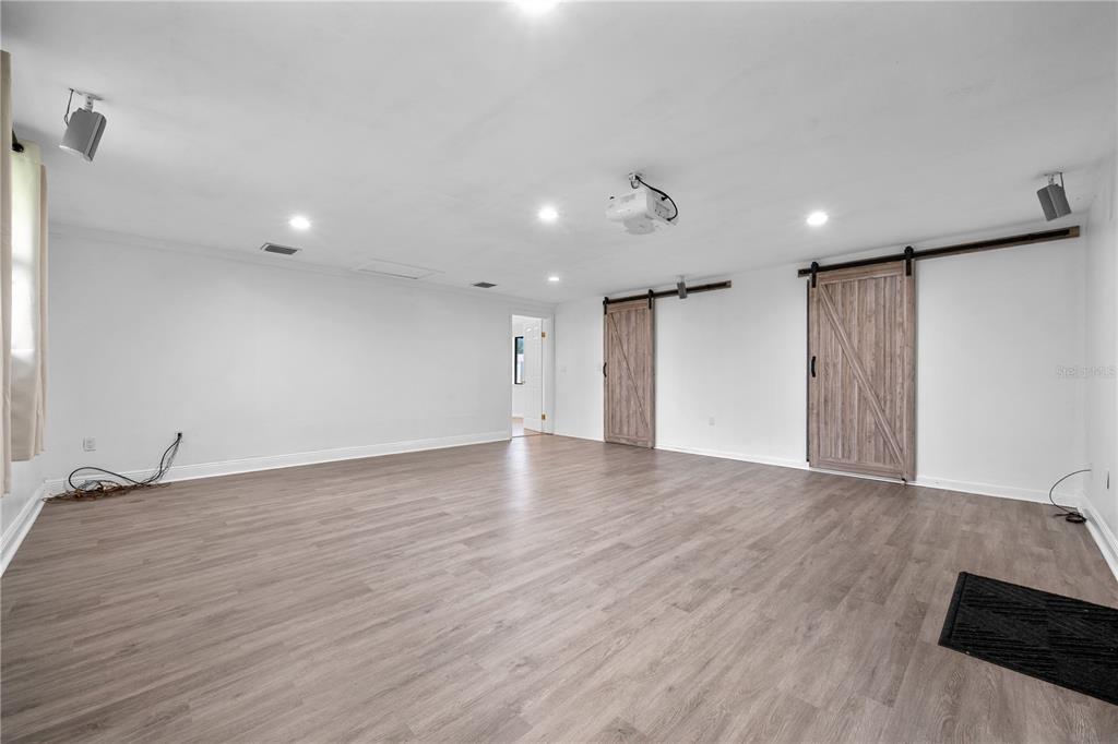 601 Oranole Road Altamonte Springs, FL 32701 - Photo 16 of 36 a view of an empty room with wooden floor and a window