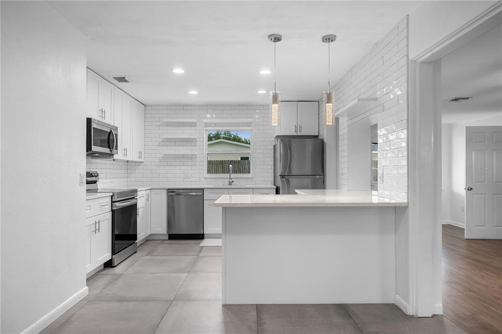 601 Oranole Road Altamonte Springs, FL 32701 - Photo 7 of 36 a large kitchen with cabinets and stainless steel appliances