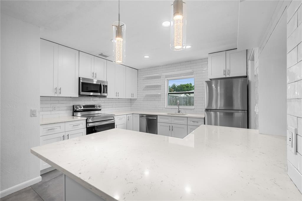 601 Oranole Road Altamonte Springs, FL 32701 - Photo 8 of 36 a kitchen with stainless steel appliances a refrigerator sink and microwave