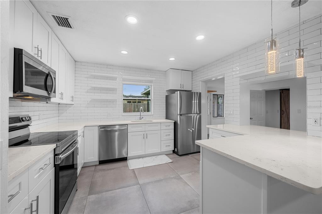 601 Oranole Road Altamonte Springs, FL 32701 - Photo 9 of 36 a kitchen with a sink microwave and refrigerator