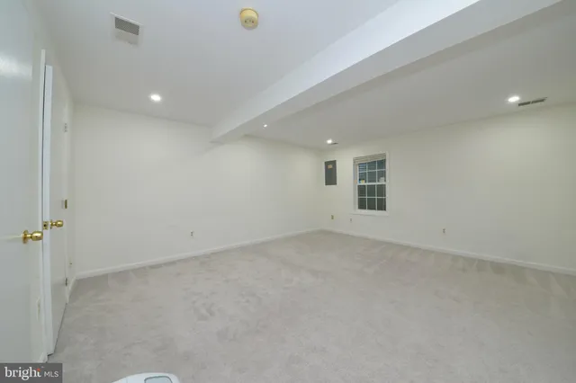 an empty room with a empty space and windows