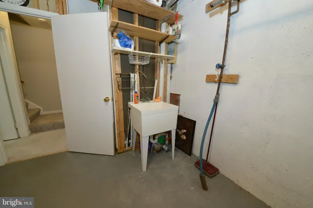 a view of hallway with furniture and a refrigerator
