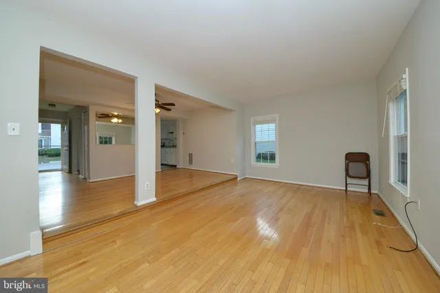 a view of empty room with wooden floor