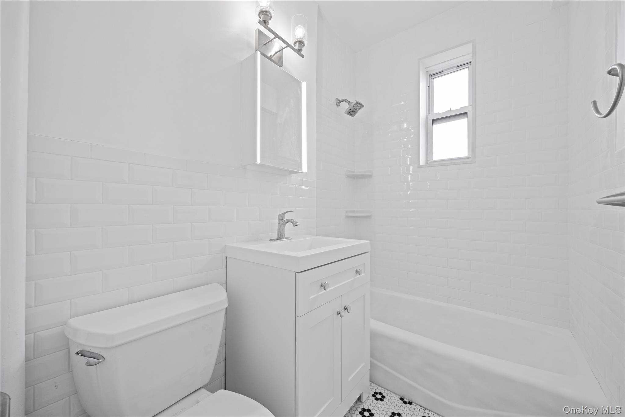 220 Pelham Road, Unit 6P New Rochelle, NY 10805 - Photo 7 of 23 a bathroom with a sink a toilet and shower