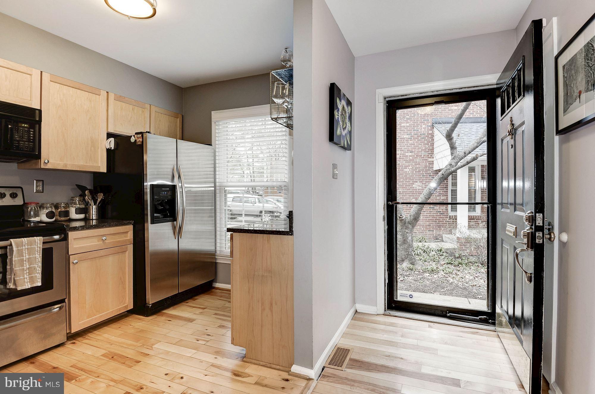 2546 South Walter Reed Drive, Unit 3 Arlington, VA 22206 - Photo 2 of 30 a kitchen with stainless steel appliances granite countertop a refrigerator and a sink