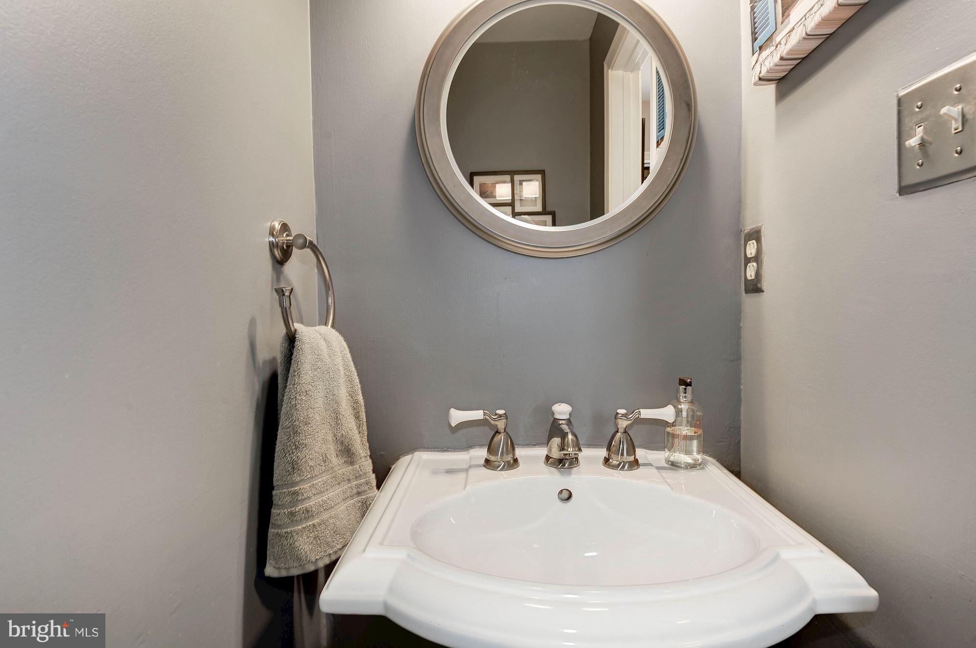 2546 South Walter Reed Drive, Unit 3 Arlington, VA 22206 - Photo 14 of 30 a bathroom with a sink and a mirror