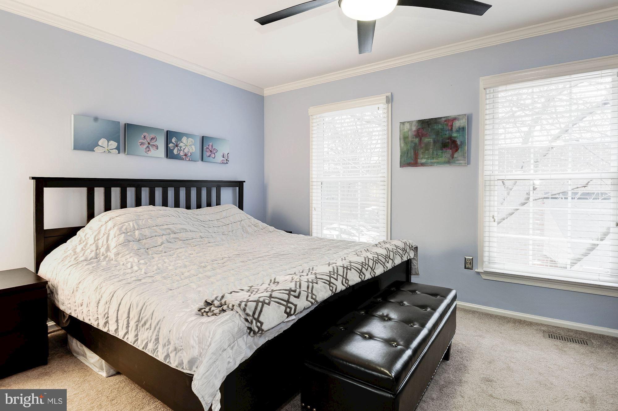 2546 South Walter Reed Drive, Unit 3 Arlington, VA 22206 - Photo 16 of 30 a bed sitting in a bedroom next to a window
