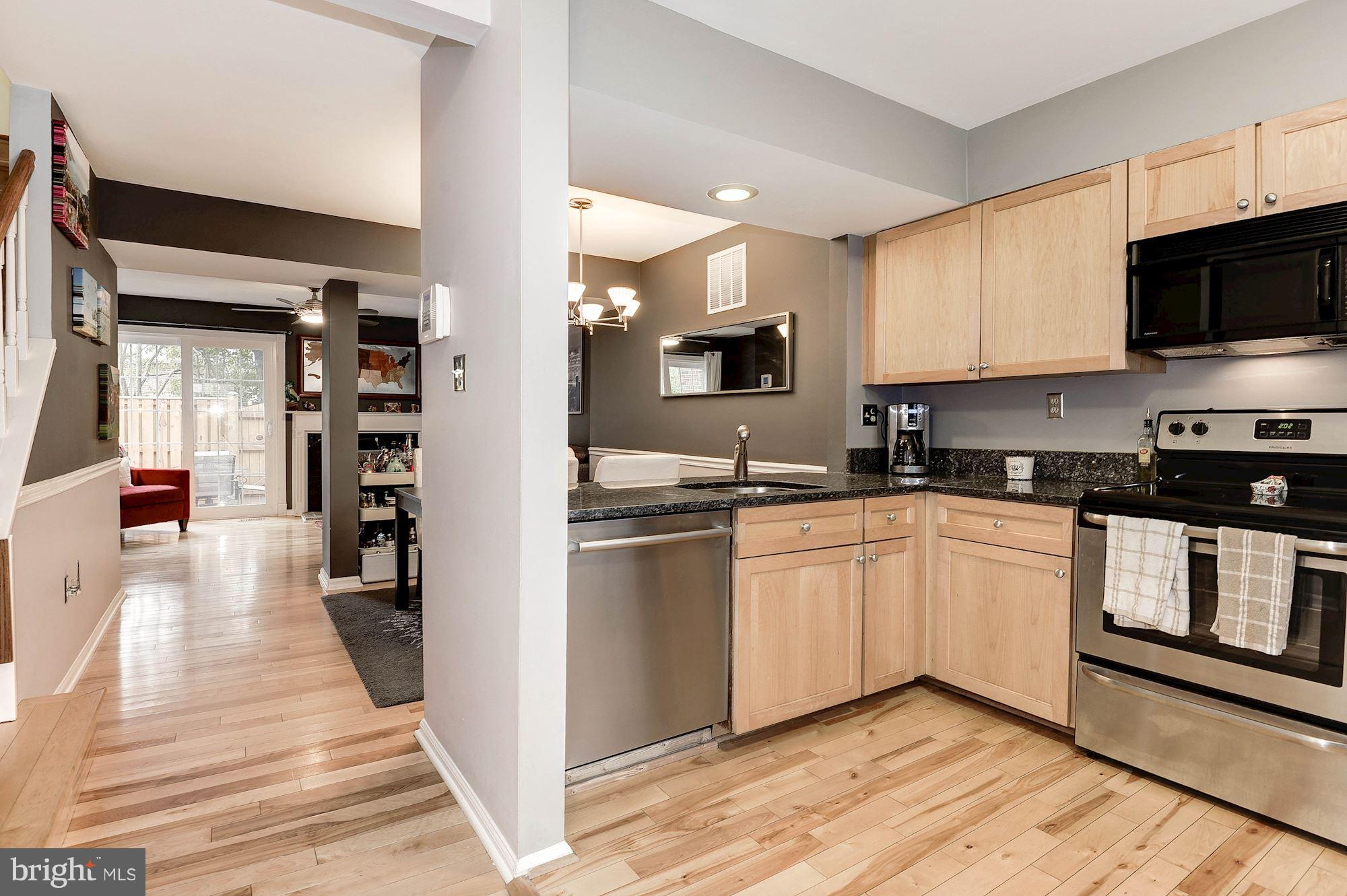 2546 South Walter Reed Drive, Unit 3 Arlington, VA 22206 - Photo 3 of 30 a kitchen with stainless steel appliances granite countertop a refrigerator and microwave