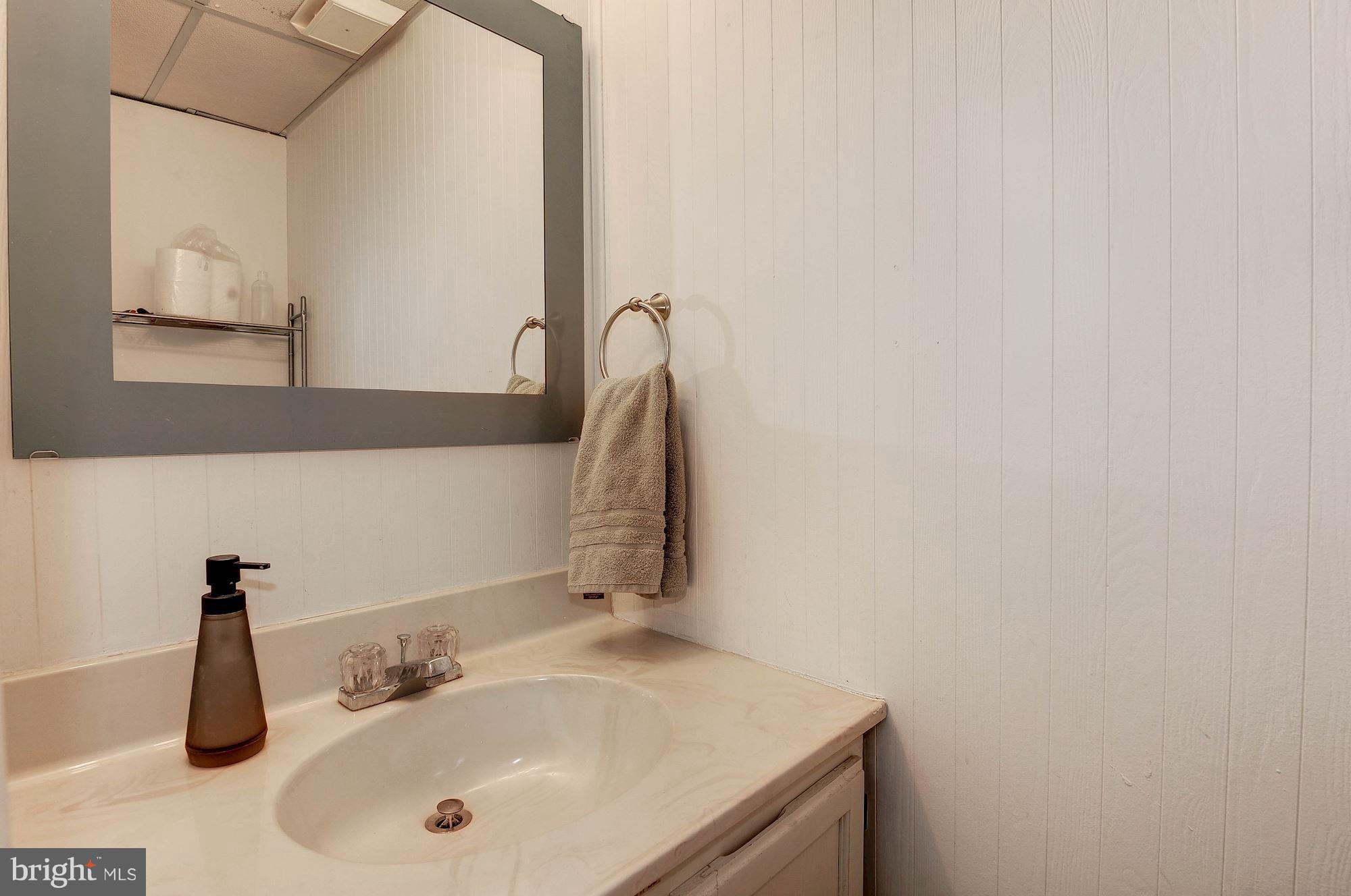 2546 South Walter Reed Drive, Unit 3 Arlington, VA 22206 - Photo 25 of 30 a bathroom with a sink and a mirror
