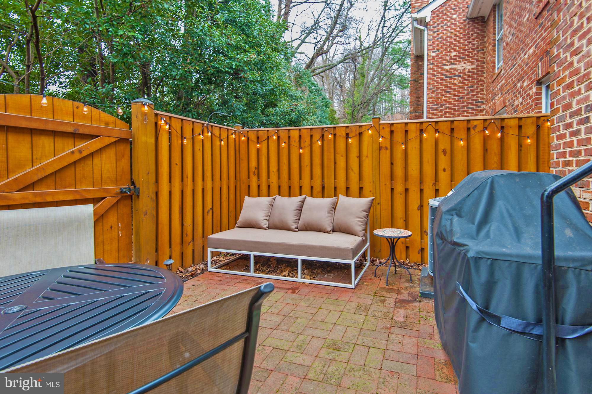 2546 South Walter Reed Drive, Unit 3 Arlington, VA 22206 - Photo 27 of 30 a backyard of a house with barbeque oven and outdoor seating