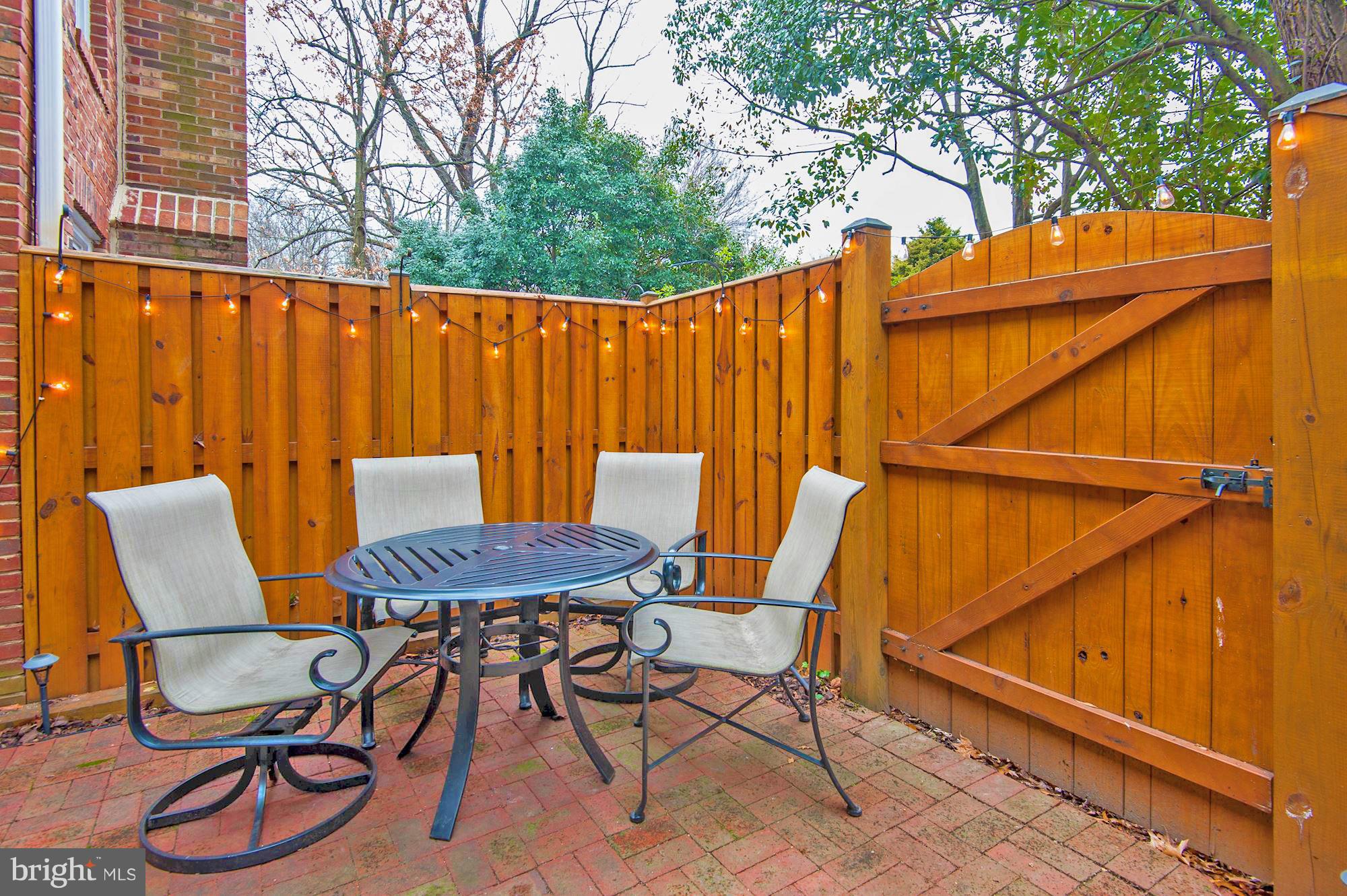 2546 South Walter Reed Drive, Unit 3 Arlington, VA 22206 - Photo 28 of 30 a patio with water glass top table and chairs