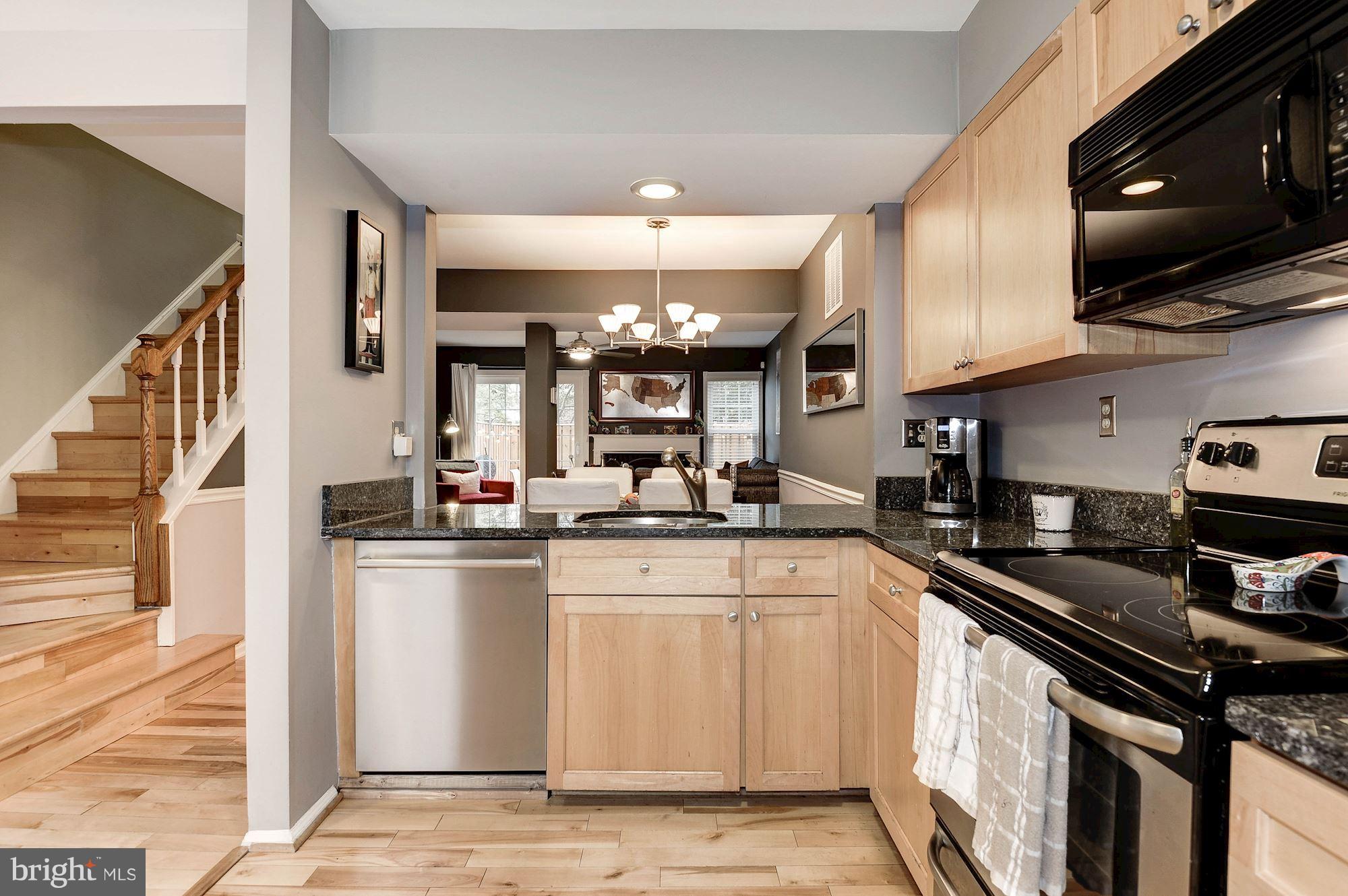 2546 South Walter Reed Drive, Unit 3 Arlington, VA 22206 - Photo 5 of 30 a kitchen with stainless steel appliances granite countertop a sink and a stove