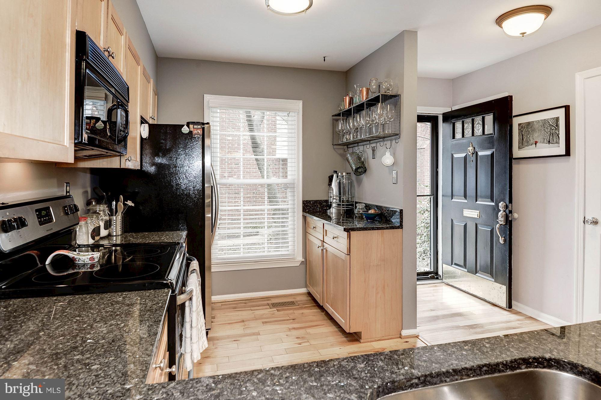 2546 South Walter Reed Drive, Unit 3 Arlington, VA 22206 - Photo 6 of 30 a kitchen with stainless steel appliances granite countertop a refrigerator and a stove