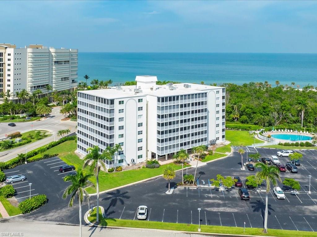 a view of a building with garden space and sitting area