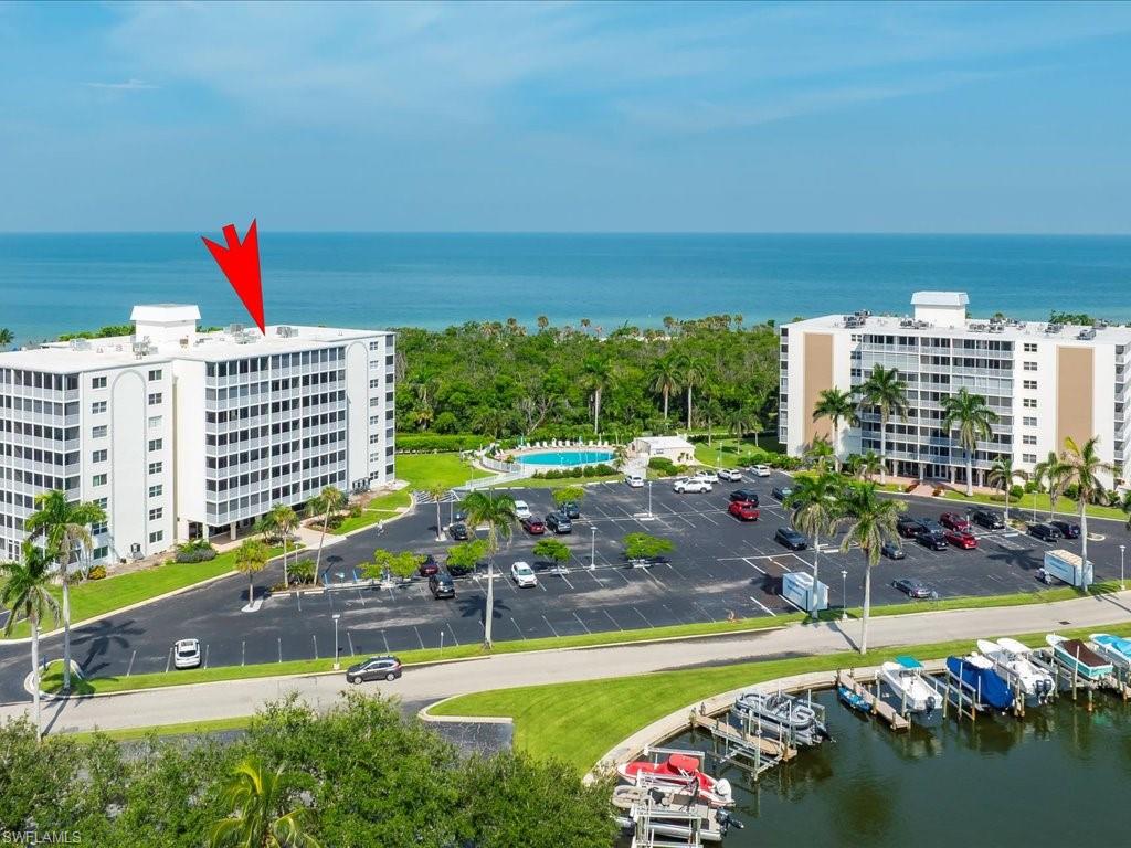 1 Bluebill Avenue, Unit 302 Naples, FL 34108 - Photo 20 of 21 a view of a swimming pool with a patio