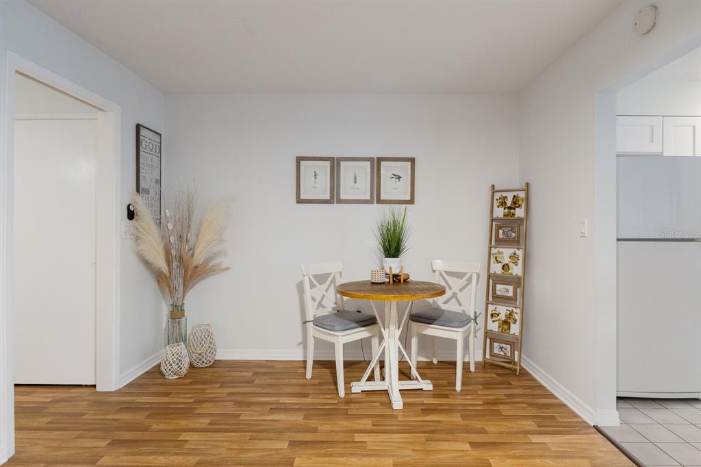 4444 Swift Road, Unit 4 Sarasota, FL 34231 - Photo 12 of 23 a view of a dining room with furniture and wooden floor