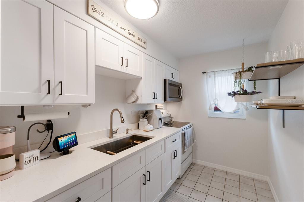 4444 Swift Road, Unit 4 Sarasota, FL 34231 - Photo 16 of 23 a kitchen with stainless steel appliances a sink a stove and cabinets