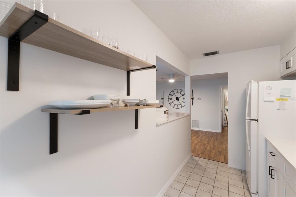 4444 Swift Road, Unit 4 Sarasota, FL 34231 - Photo 17 of 23 a view of kitchen with refrigerator and white cabinets