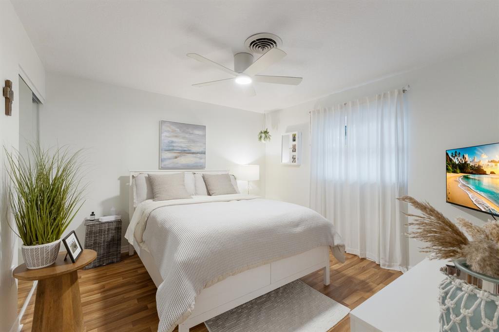 4444 Swift Road, Unit 4 Sarasota, FL 34231 - Photo 19 of 23 a bedroom with a bed and a flat screen tv