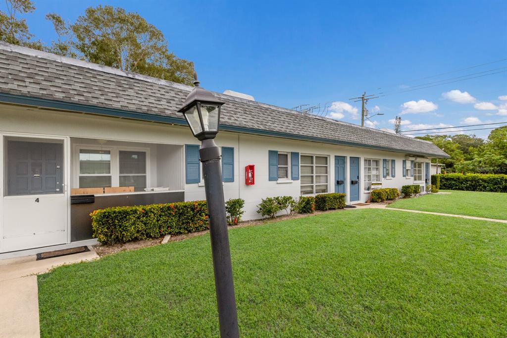 4444 Swift Road, Unit 4 Sarasota, FL 34231 - Photo 2 of 23 a front view of a house with a yard