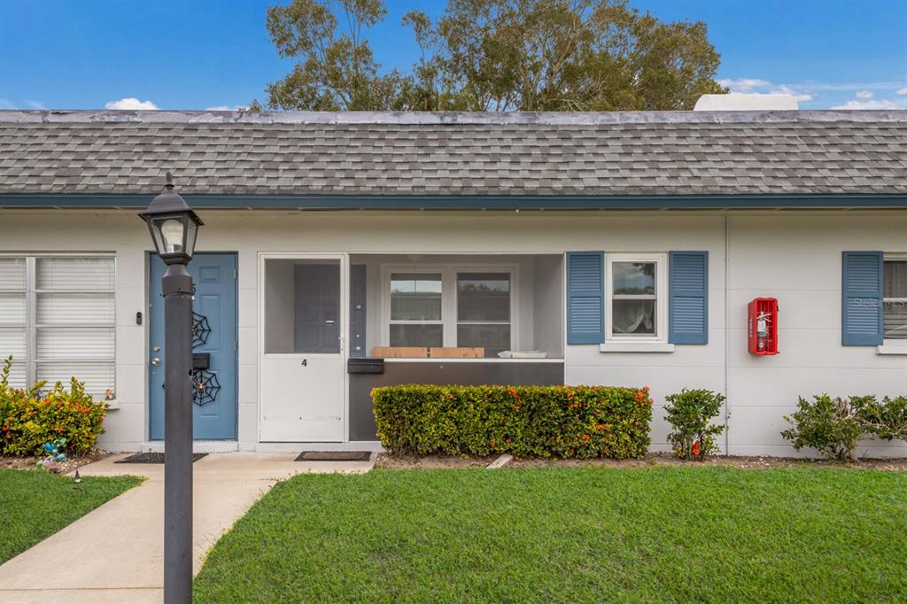 4444 Swift Road, Unit 4 Sarasota, FL 34231 - Photo 3 of 23 a front view of a house with a yard