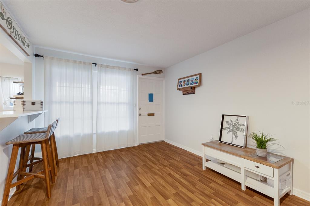 4444 Swift Road, Unit 4 Sarasota, FL 34231 - Photo 6 of 23 a bedroom with a bed and wooden floor