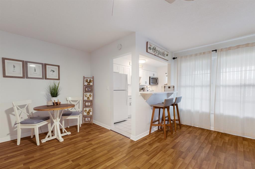 4444 Swift Road, Unit 4 Sarasota, FL 34231 - Photo 8 of 23 a view of a dining room with furniture and wooden floor
