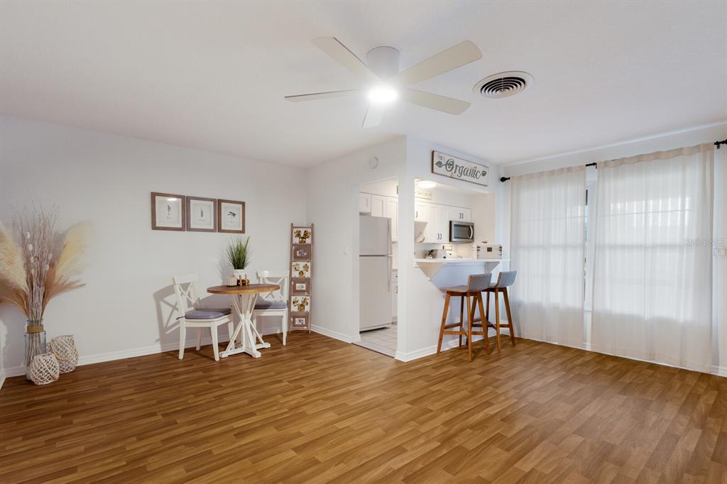 4444 Swift Road, Unit 4 Sarasota, FL 34231 - Photo 9 of 23 a view of a dining room with furniture and wooden floor