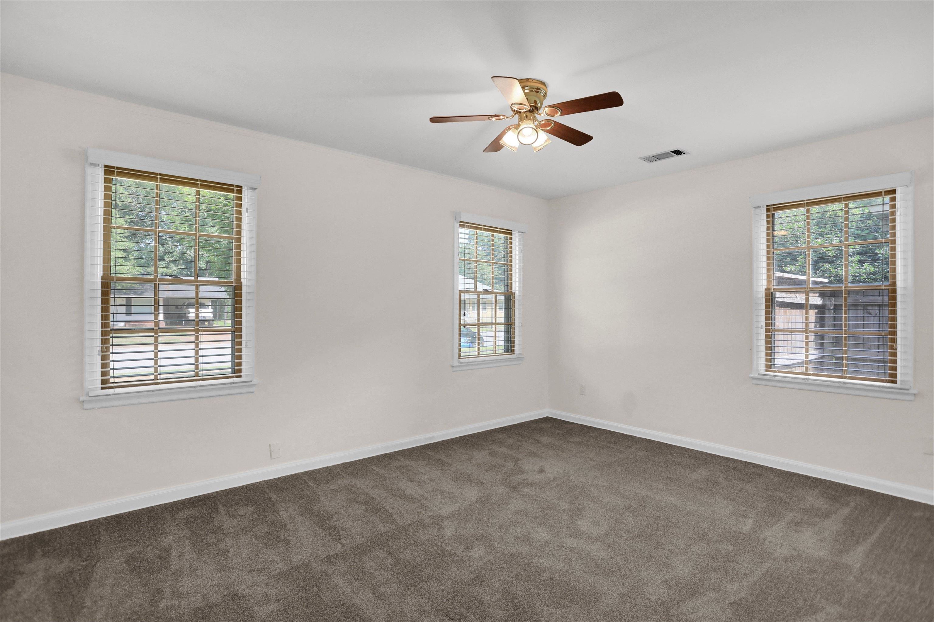 4545 Flamingo Road Memphis, TN 38117 - Photo 24 of 34 Neutral tone walls with multiple windows featuring horizontal blinds