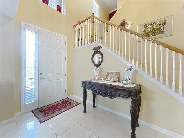 a kitchen with stainless steel appliances kitchen island granite countertop a sink and a refrigerator