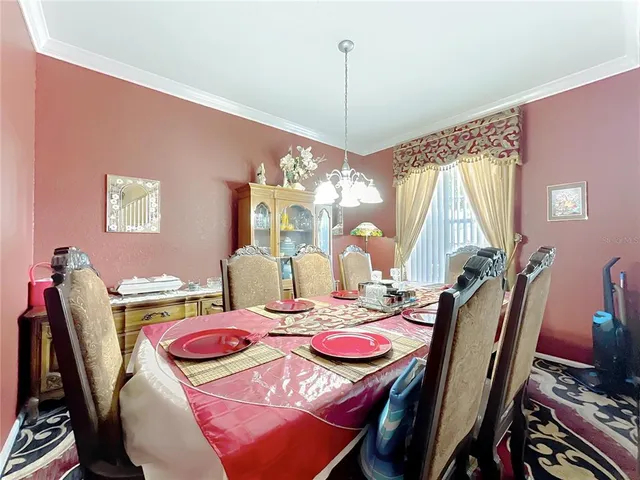 a view of a dining room with furniture and a large window