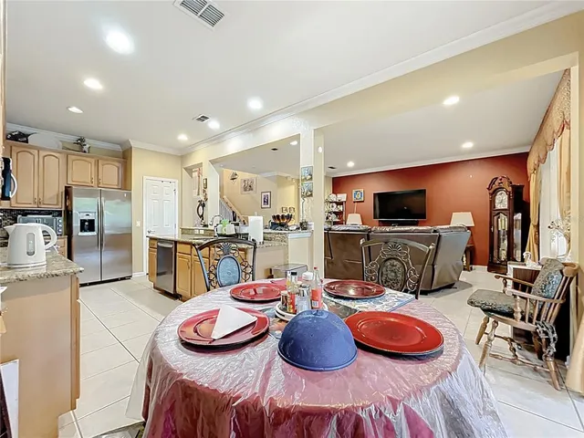 a living room with furniture a flat screen tv and a floor to ceiling window