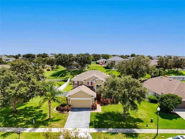 an aerial view of a house with a yard