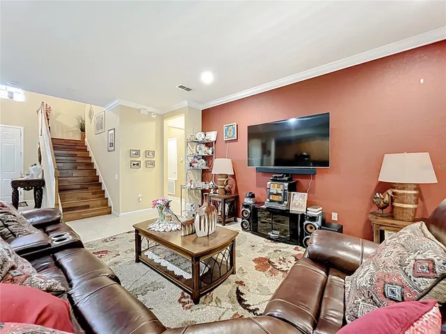 a living room with furniture and a flat screen tv