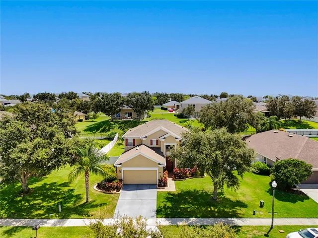 an aerial view of a house with a yard