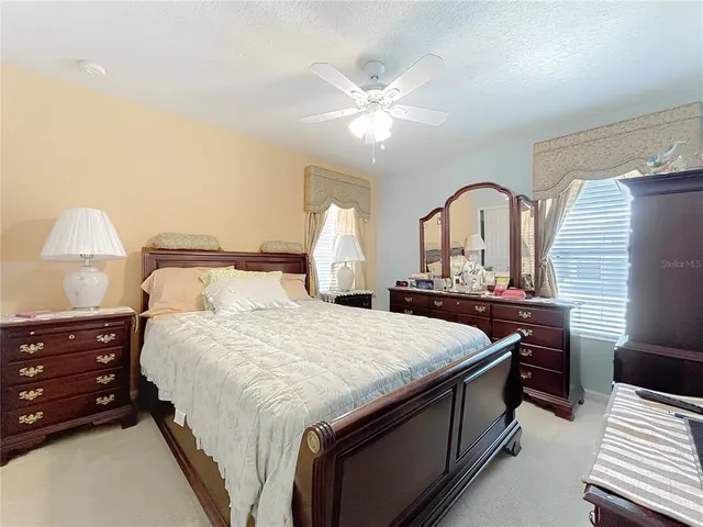 a living room filled with furniture and a potted plant