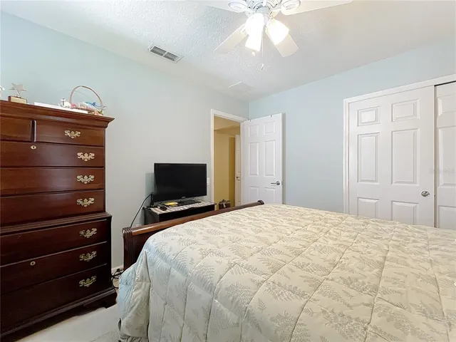 a view of a patio with dining table and chairs under an umbrella
