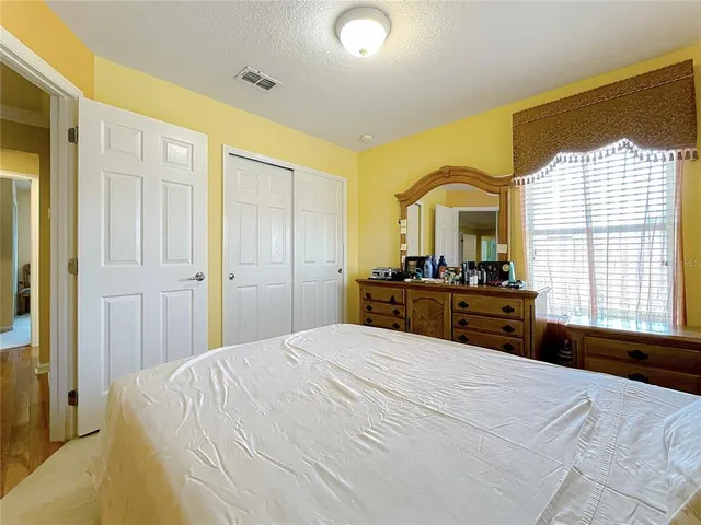 an aerial view of a city with lots of residential buildings and ocean view in back