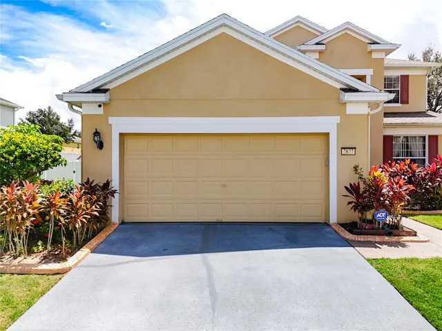 a kitchen with stainless steel appliances granite countertop a sink a stove and a wooden cabinets
