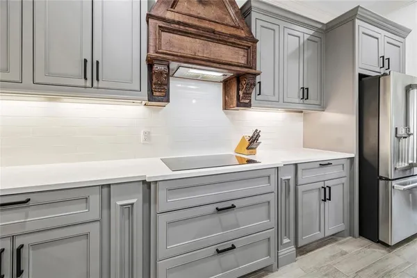a stove top oven sitting inside of a kitchen