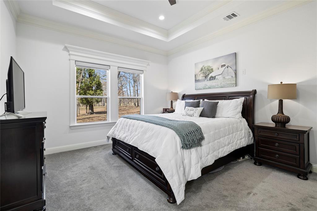 203 Colonial Drive Mabank, TX 75156 - Photo 14 of 36 a spacious bedroom with a bed a couch and a window