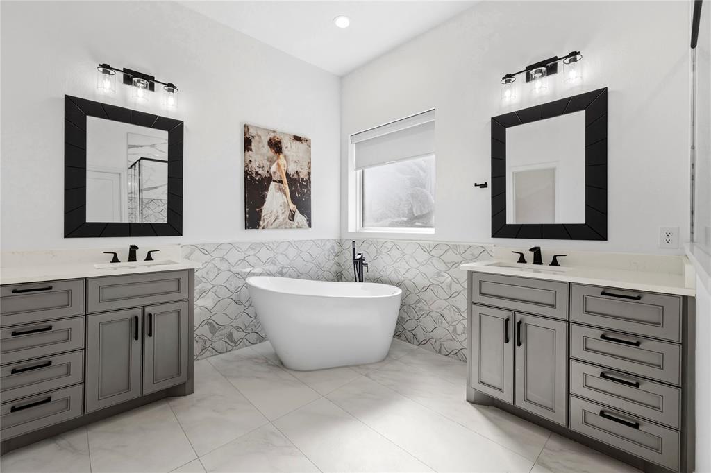 203 Colonial Drive Mabank, TX 75156 - Photo 15 of 36 a bathroom with a double vanity sink mirror and bathtub