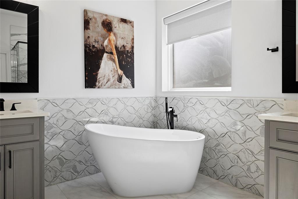 203 Colonial Drive Mabank, TX 75156 - Photo 19 of 36 a white bath tub sitting in a bathroom