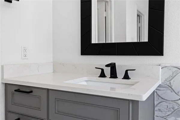 a bathroom with a sink and a mirror