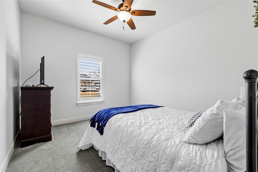 203 Colonial Drive Mabank, TX 75156 - Photo 25 of 36 a bedroom with a bed and wooden floor
